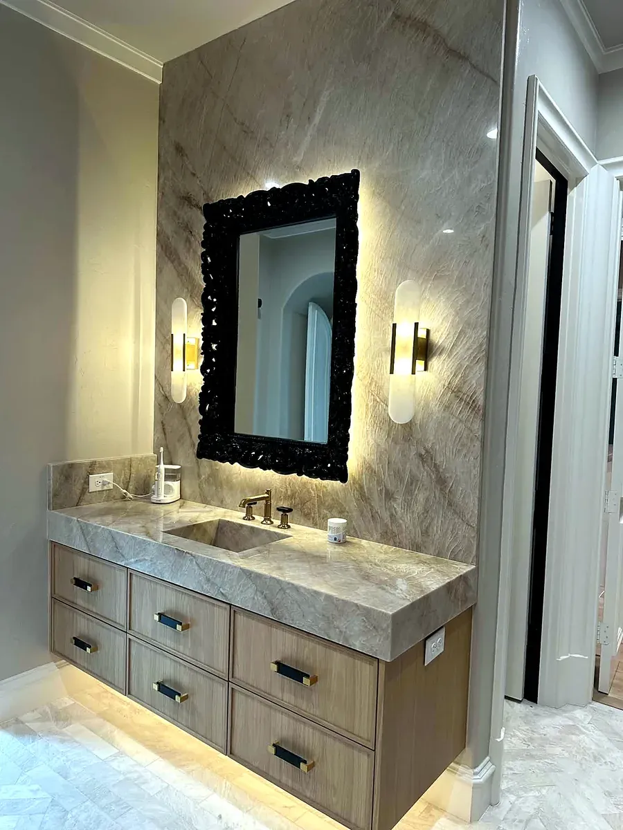 Bathroom vanity with a full height marble slab backsplash and floating oak cabinetry